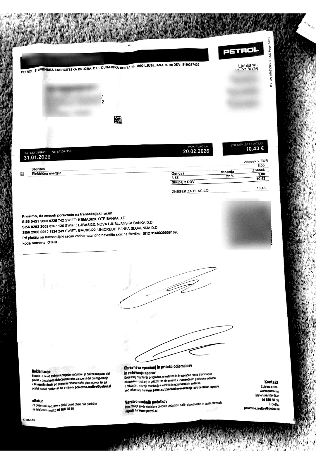 A poorly scanned invoice with heavy dark marks across the page